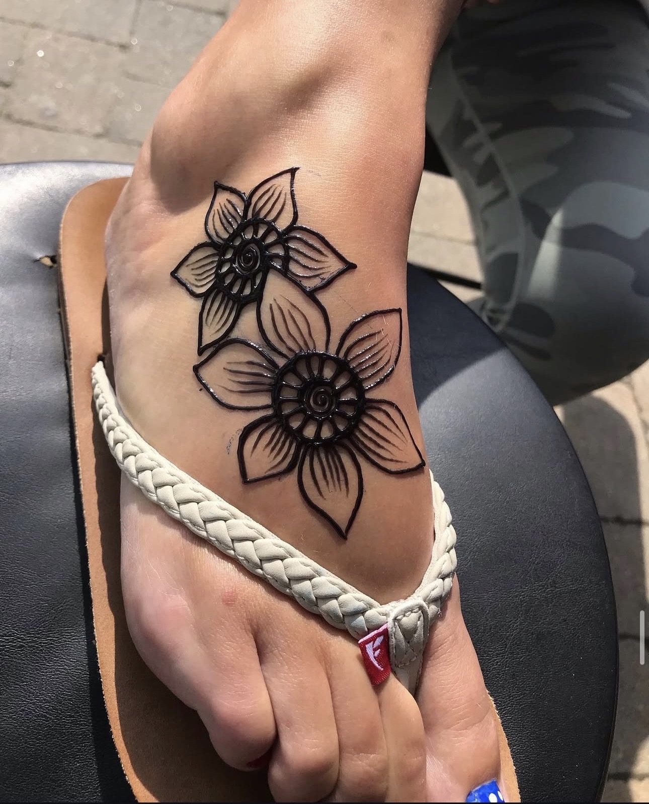 Three hands with floral henna