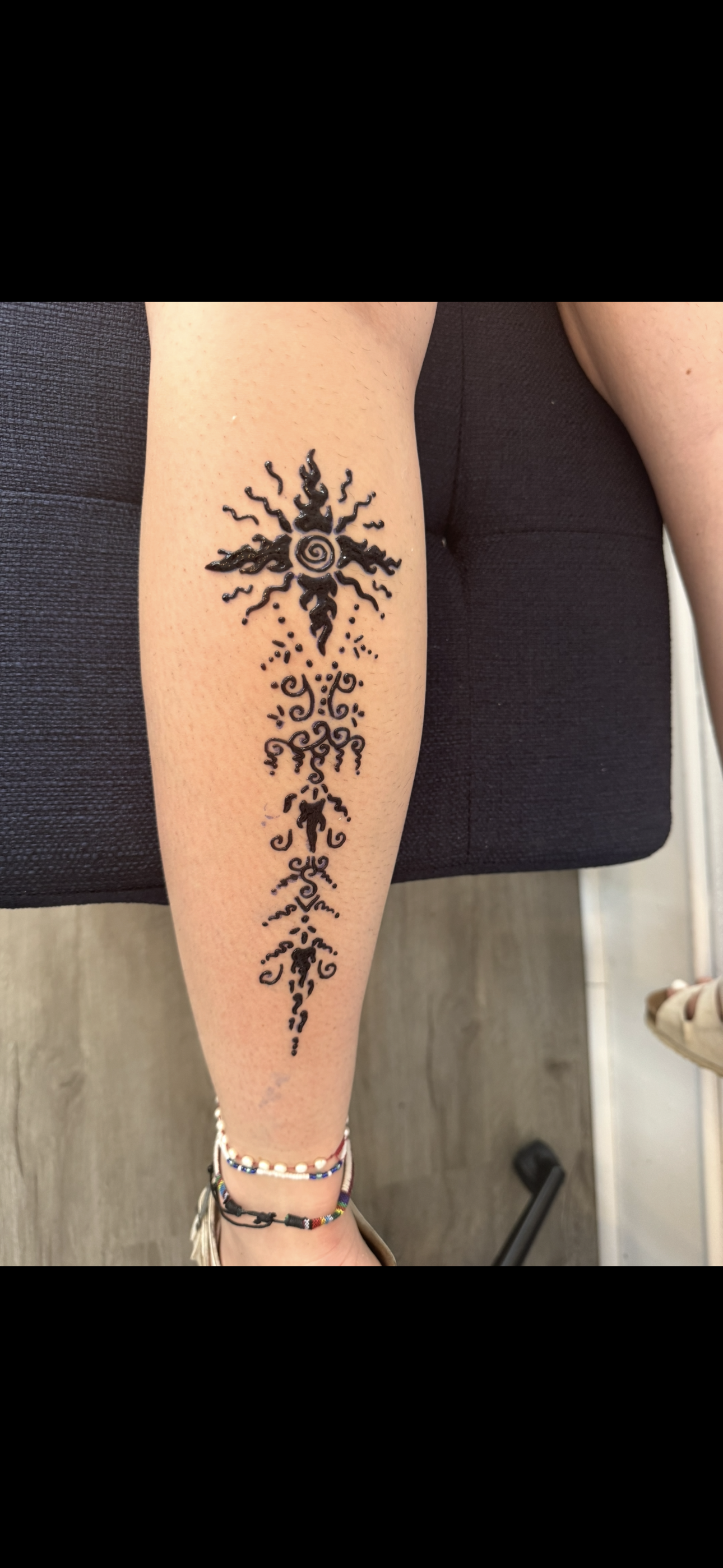 Flower and turtle henna on back of neck